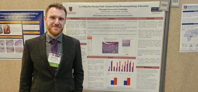 Dr. Nickolas Phillipow standing beside his poster of Leveling the Playing Field.