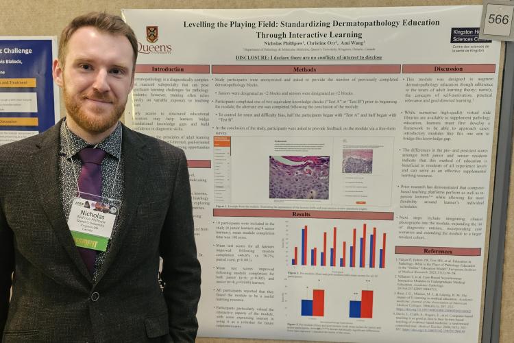 Dr. Nickolas Phillipow standing beside his poster of Leveling the Playing Field.